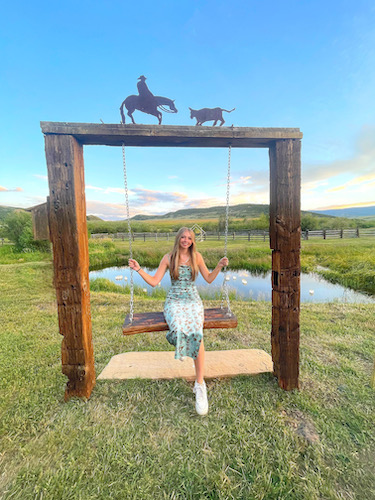 Lorin Jones sitting on a swing.